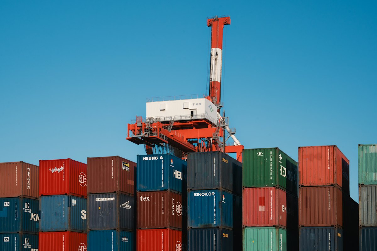 Gantry cranes above stacked shipping containers at a container terminal